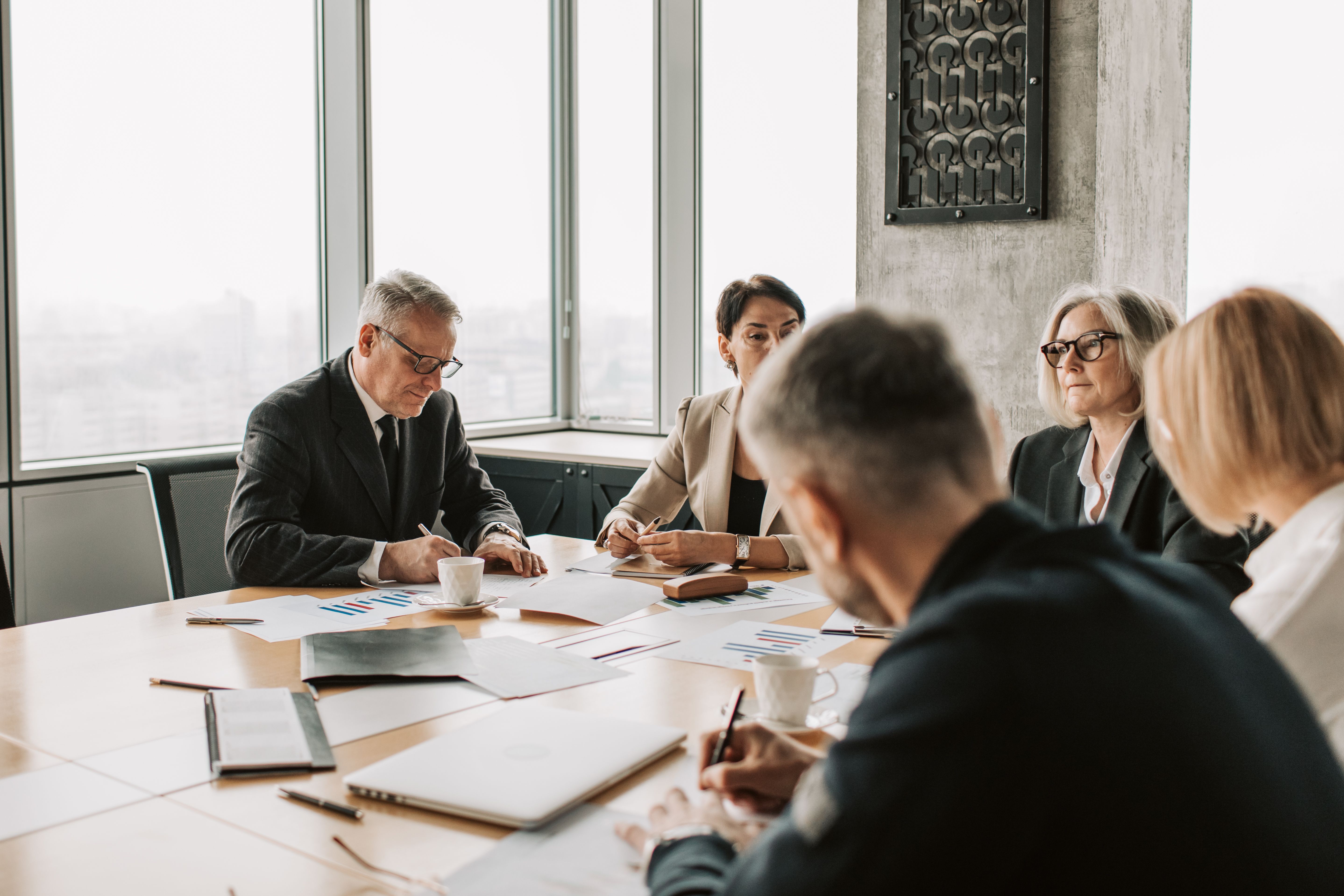 Professionals discussing reports around a conference table