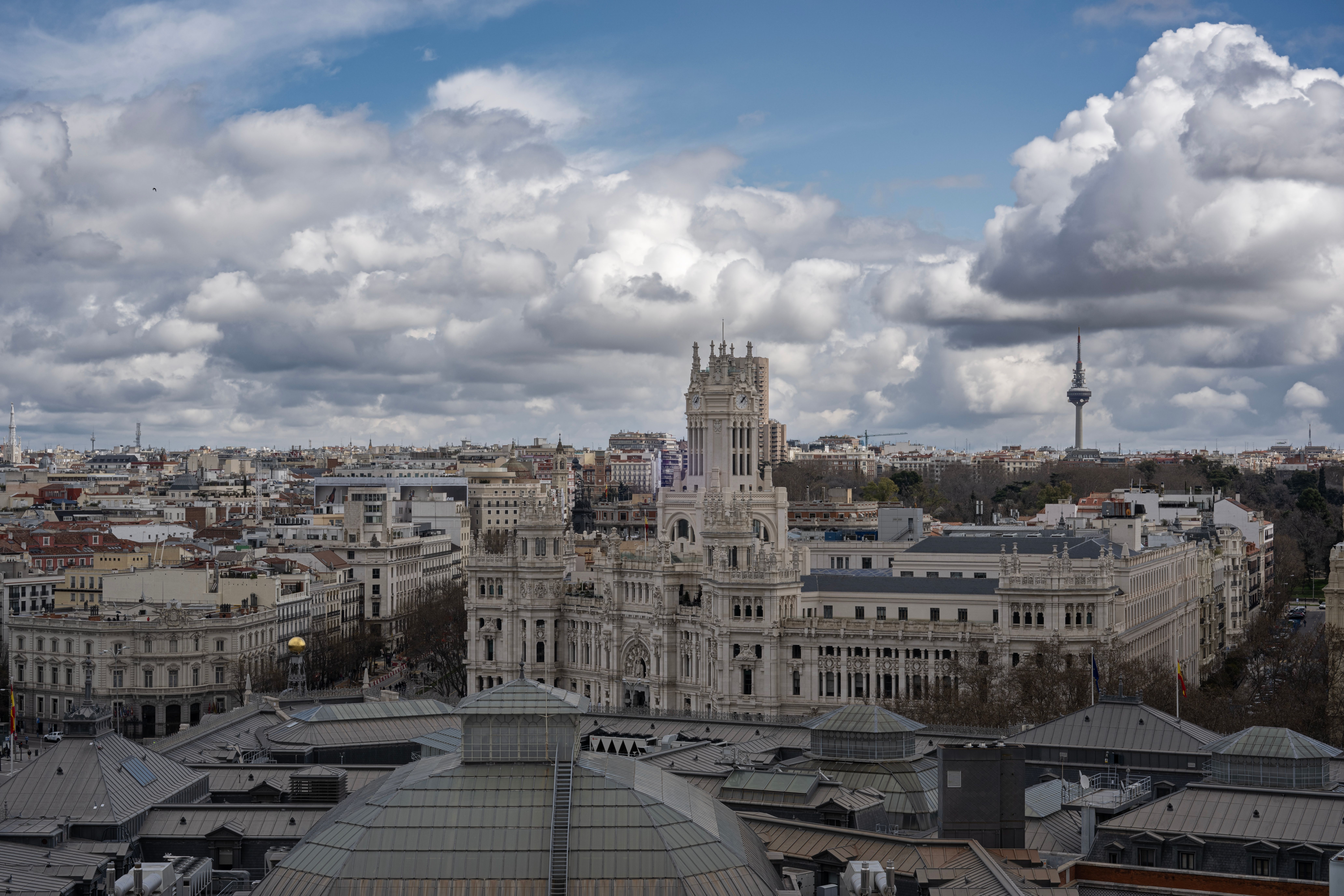 The Palacio de Cibeles and the Madrid skyline under a cloudy sky